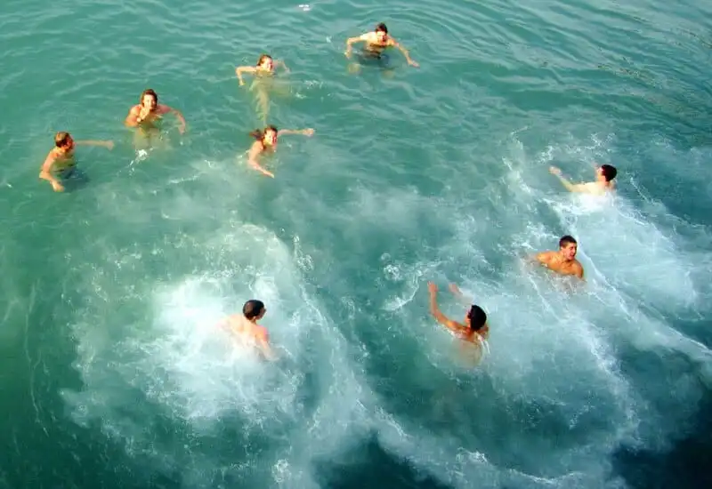 Travelers swimming in Halong Bay