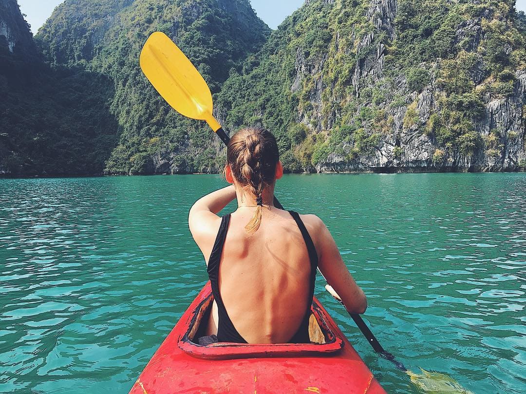 Travelers kayaking in Halong Bay