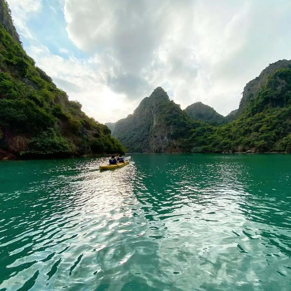 Travelers explore Dark and Bright cave by kayaking