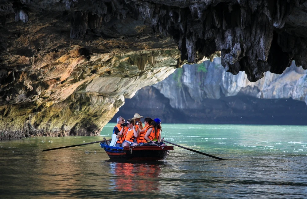 Travelers sailing along Dark & Bright Cave