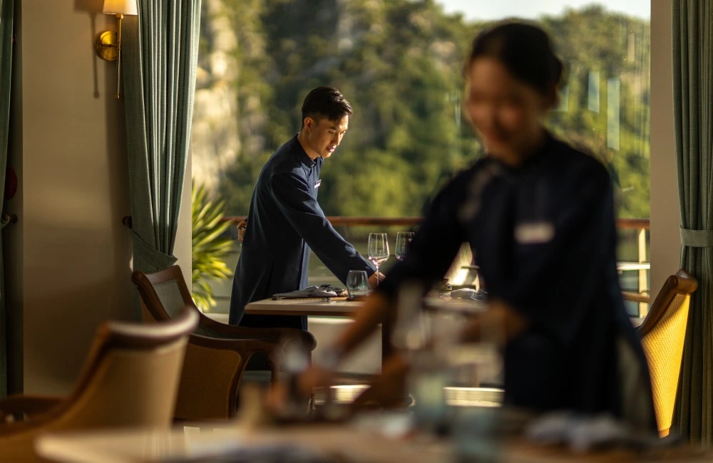Cruise crew preparing meal on board. 
