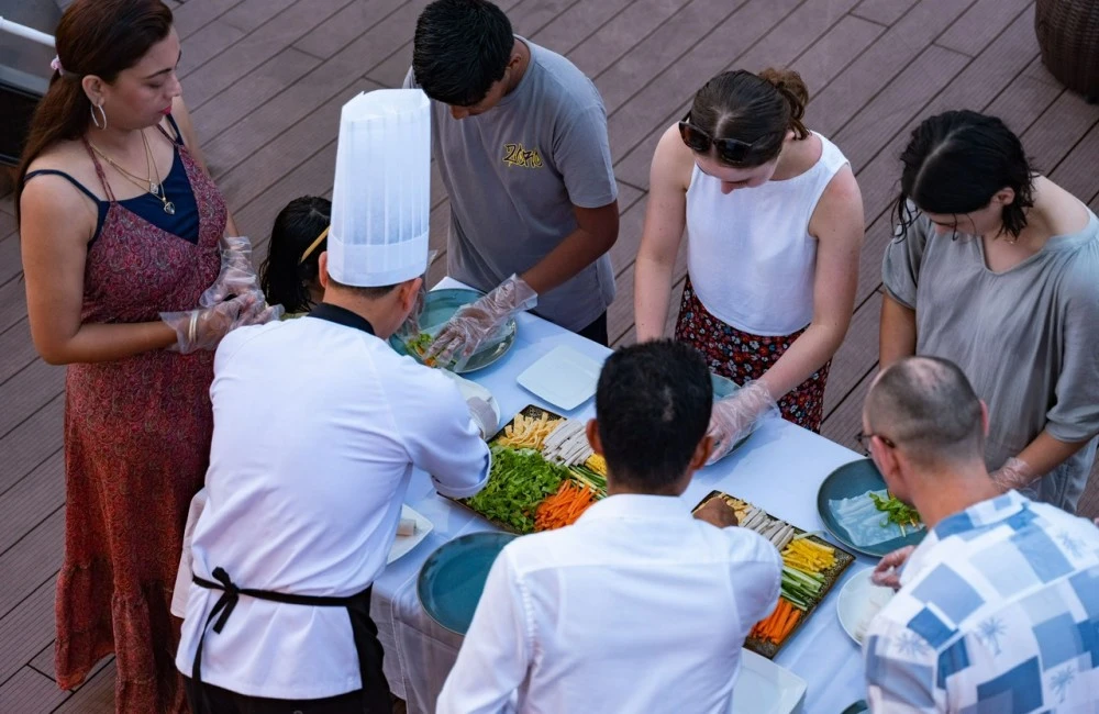 Passengers joining cooking class on board