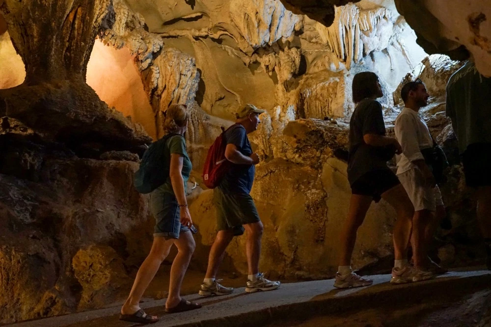 Travelers explore Trung Trang Cave