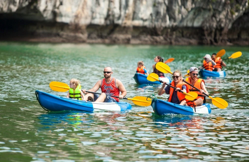 Travelers kayaking in Halong Bay on a 3 days 2 nights cruise adventure